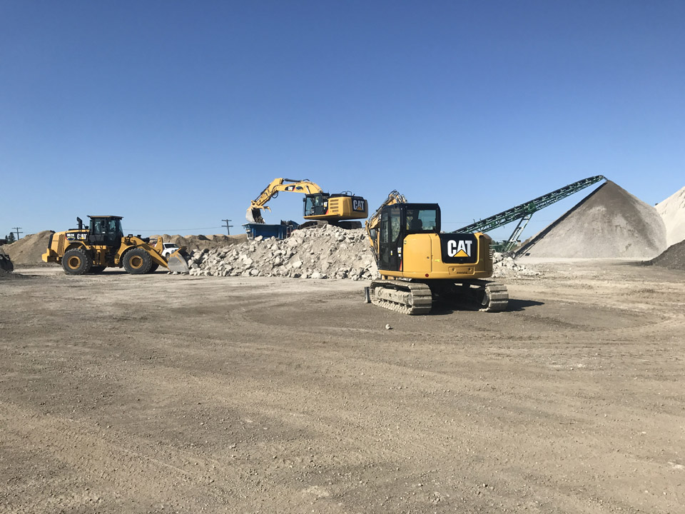 cats working on pile of asphalt, southern alberta
